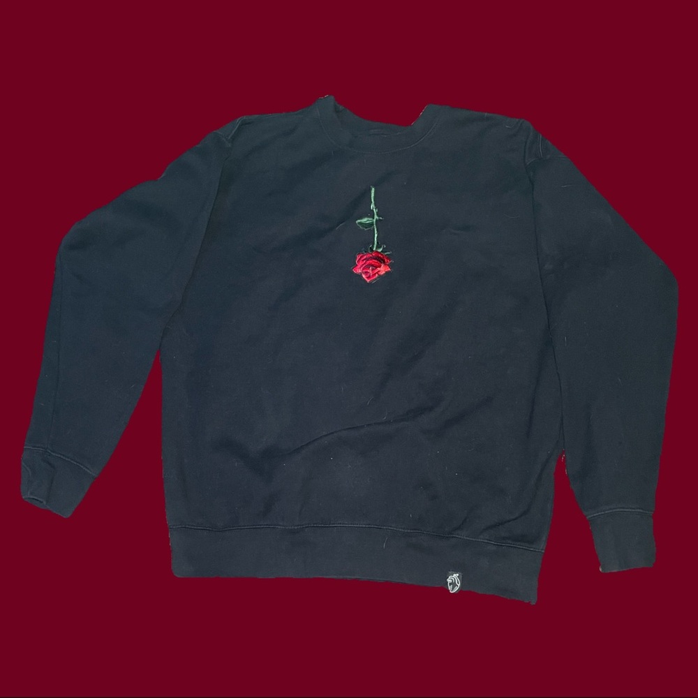 Large sewn upside rose black crewneck sweater